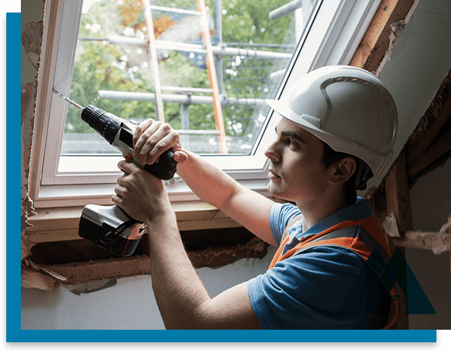 Construction worker drilling near a window